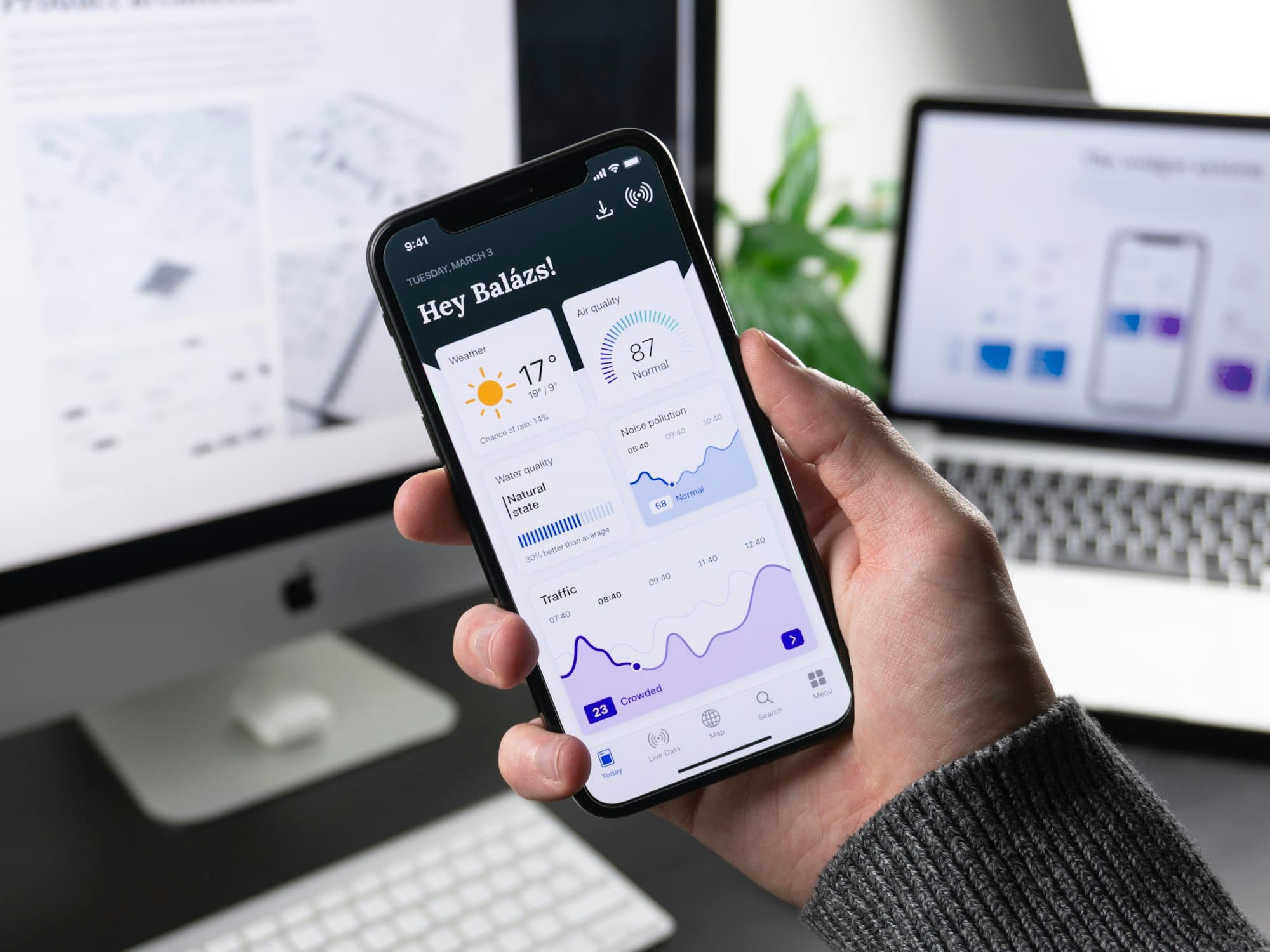 Hand holding a smartphone showing a banking app