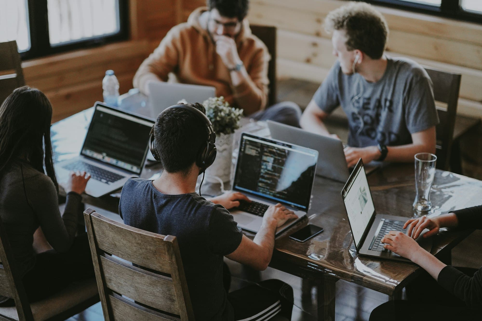 Team of developers working together at laptops